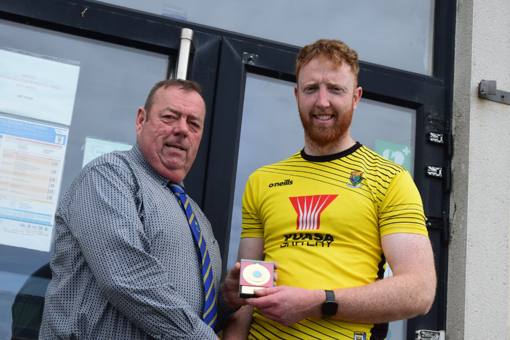 Bob Fitzgerald being presented with his 2026 Wicklow Poc Fada winners medal from County Chairman Damian Byrne